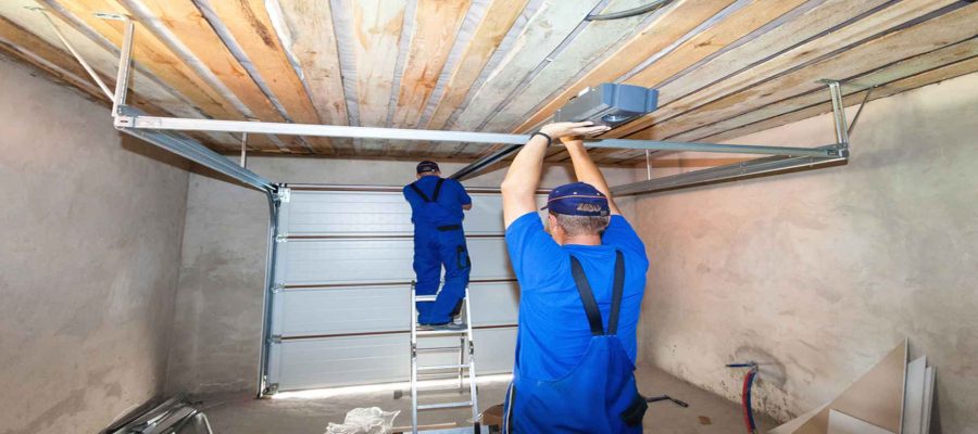 Two Men Fixing Garage Door Panels-Garage Door Panel Replacement