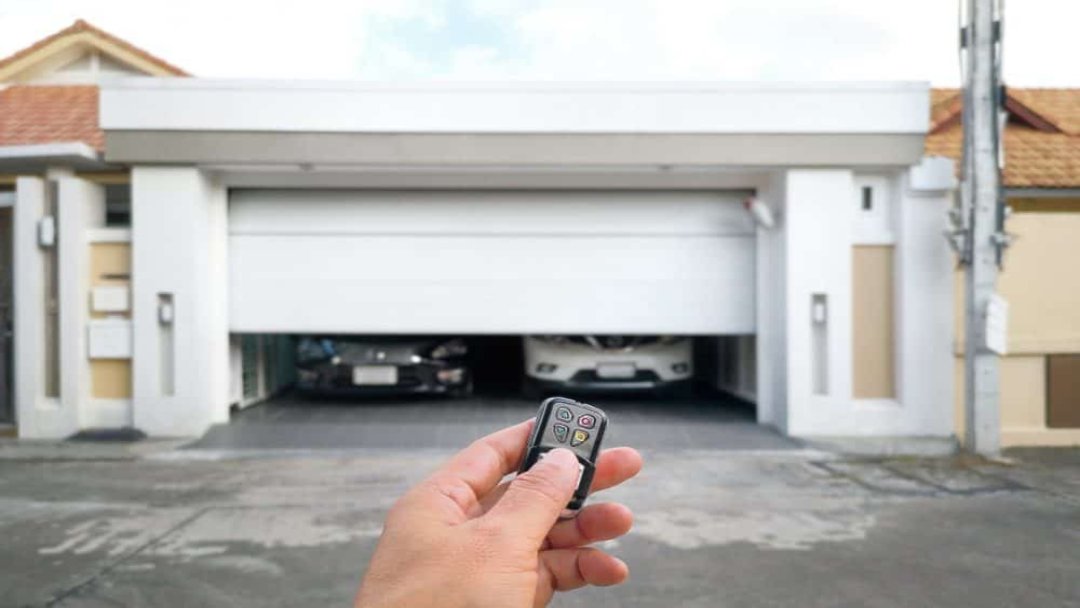 hand_opening_a_2_car_garage_with_a_remote_-_garage_door_repairs_in_pensacola_-_pensacola_overhead_door_&_operator.jpg