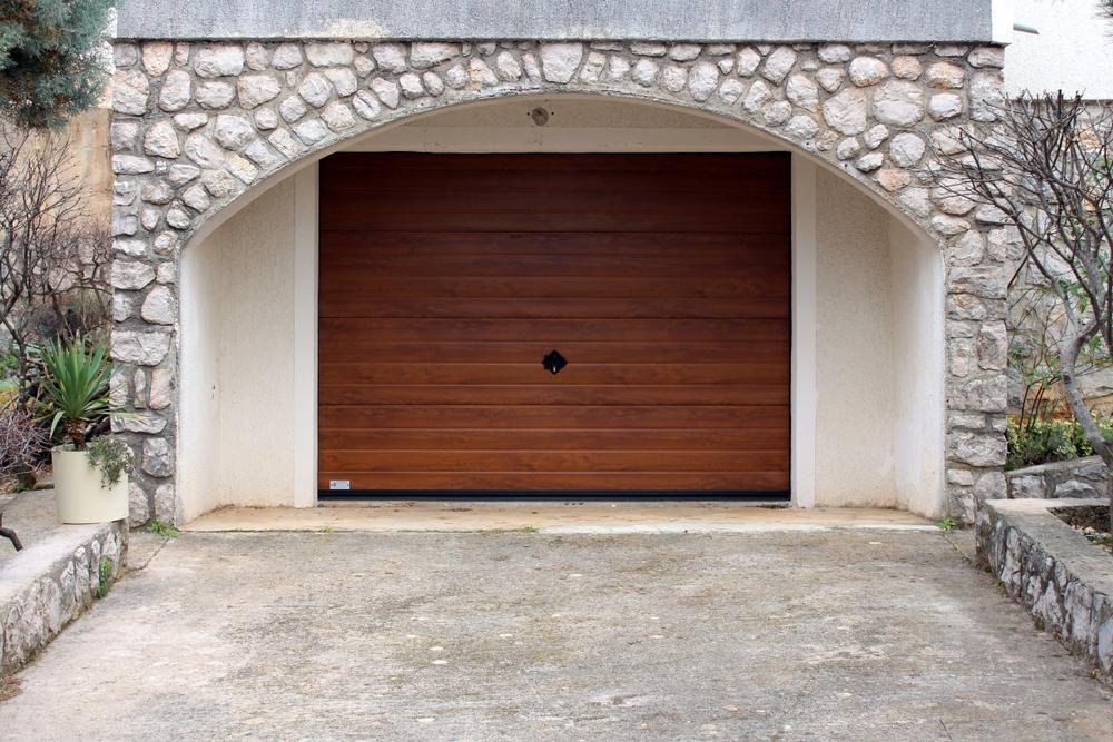 stone_paved_garage_with_wooden_garage_door_-_garage_door_repairs_in_pensacola_-_pensacola_overhead_door_&_operator.jpg